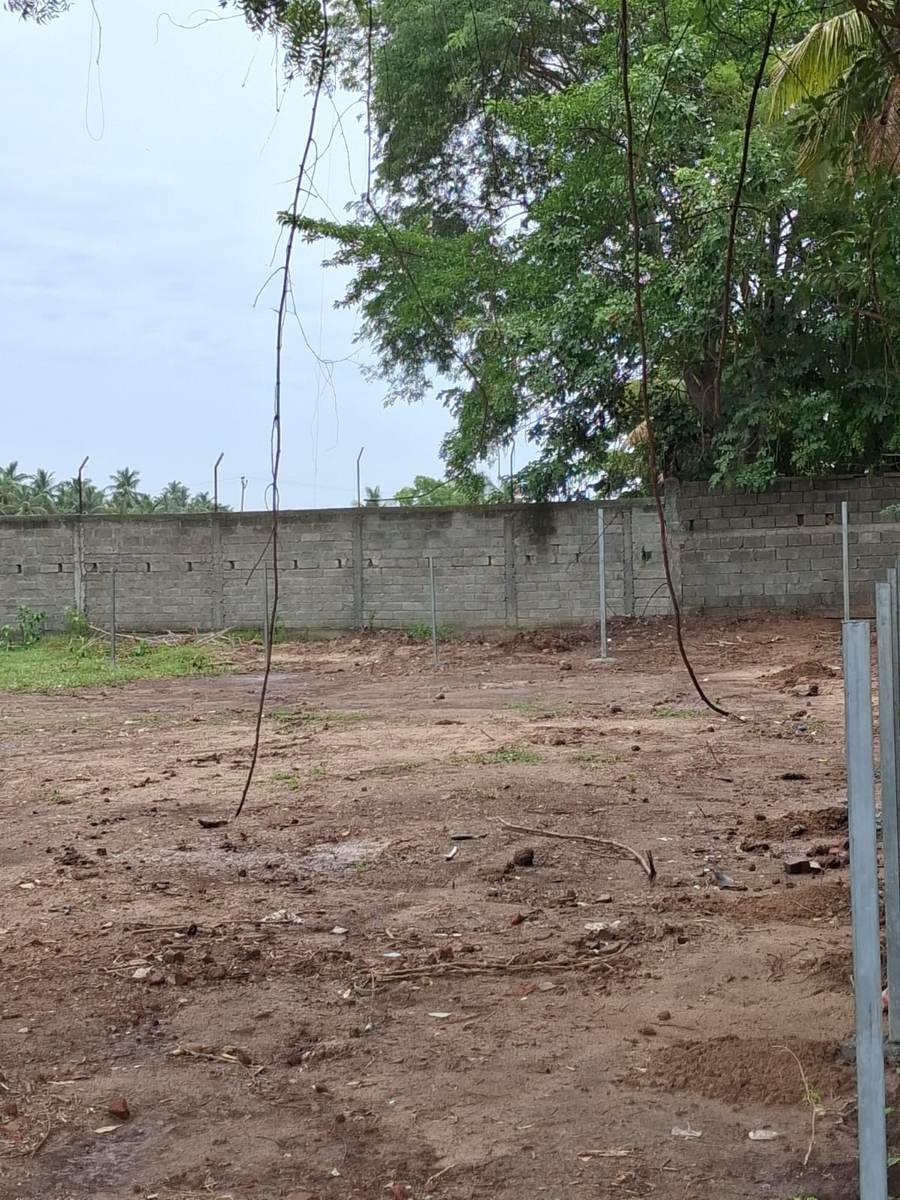 Cleared SWM site with boundary wall and temporary fencing posts
